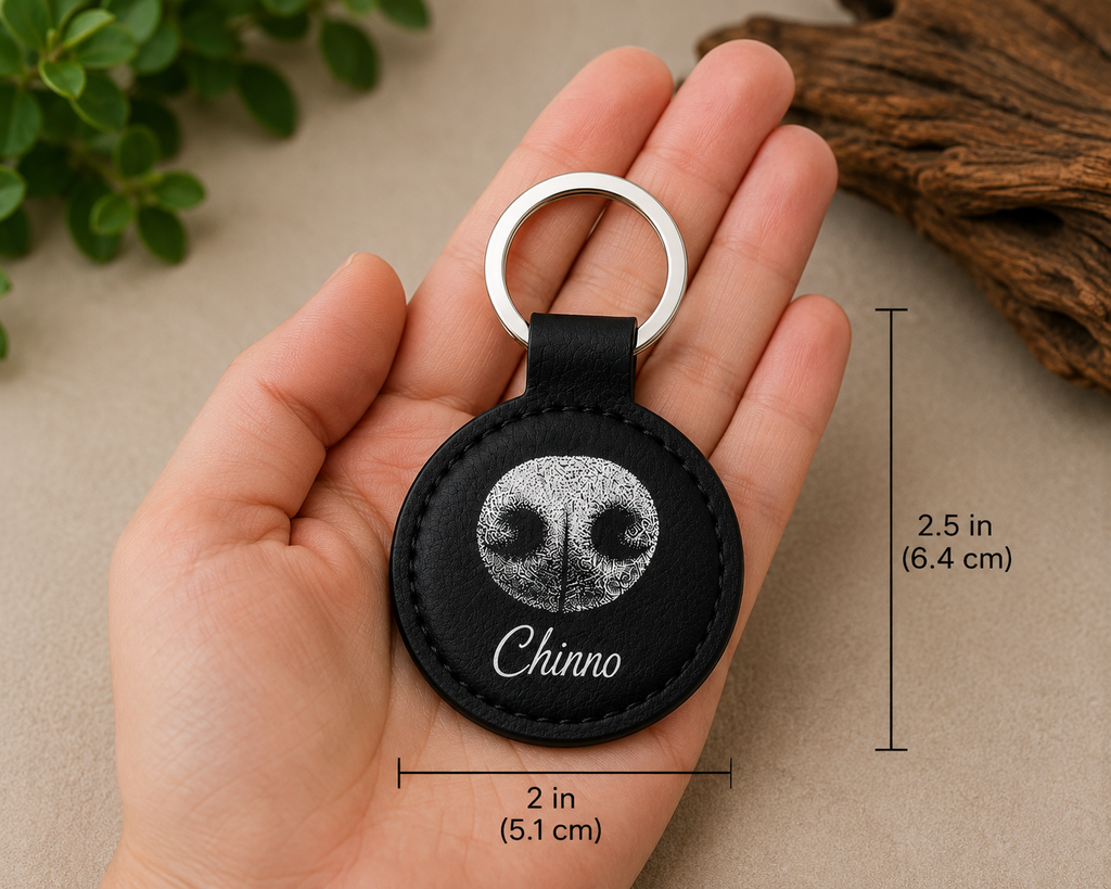 Signature NosePrint keychain shown in hand for size reference